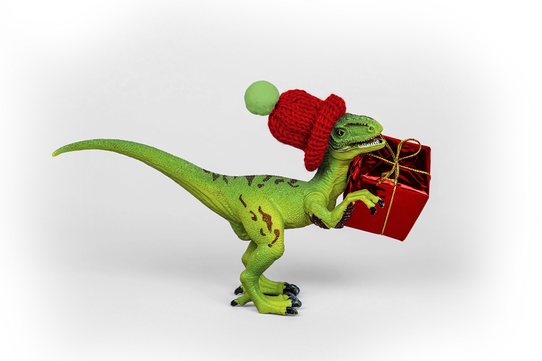 Imagen de un velociraptor con un regalo y un sombrero